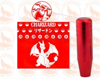 May include: A cylindrical red metal gear shift knob next to a square graphic featuring the character Charizard, the text "CHARIZARD" and "リザードン", and rows of small circular icons including Poké Balls and fire symbols on a bright red background.