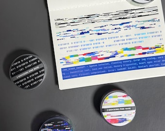 May include: Several round stickers with a digital glitch design and the text "SHOCKING PINK ROSE." The stickers have a black, white, and pink color scheme. A piece of paper with binary code and error messages is also visible.