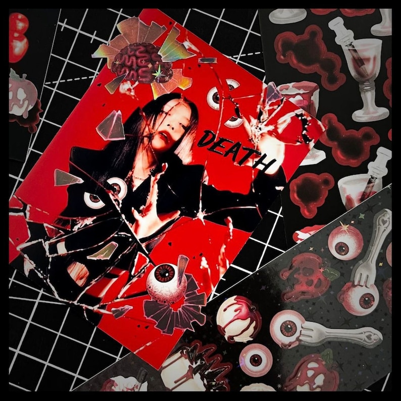 May include: A red and black sticker sheet with a woman's face in the center. The sticker sheet has a cracked glass effect and the word "DEATH" written in white. The sticker sheet is surrounded by other stickers with various designs, including eyes, skulls, and forks.