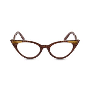 May include: Brown cat-eye glasses with gold accents and a leopard print frame.