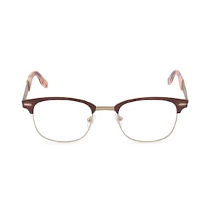 May include: Eyeglasses with a brown upper frame and gold-colored lower frame. The temples are a tortoiseshell pattern. The lenses are clear. The glasses are set against a white background.