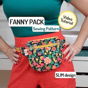 Puede incluir: Un cinturón con estampado floral con cremallera y correa amarillas se lleva alrededor de la cintura. El cinturón tiene un fondo negro con flores coloridas. El texto "FANNY PACK Sewing Pattern" se muestra encima del cinturón. El texto "SLIM design" se muestra debajo.