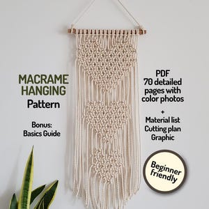 May include: A beige macrame wall hanging with a heart pattern, suspended from a wooden dowel. The text on the image reads "MACRAME HANGING Pattern" and "Beginner friendly". Includes a PDF with 70 pages of color photos, a material list, and a cutting plan.
