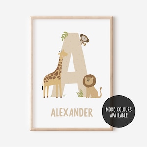 May include: A beige letter A with a giraffe, lion, and monkey illustration. The name Alexander is printed below the letter. The image has a brown wood frame.