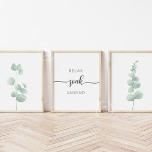 May include: Three framed prints with a minimalist design. The center print features the text "Relax soak unwind" in black script font. The left and right prints feature a watercolor illustration of a eucalyptus branch in shades of green.