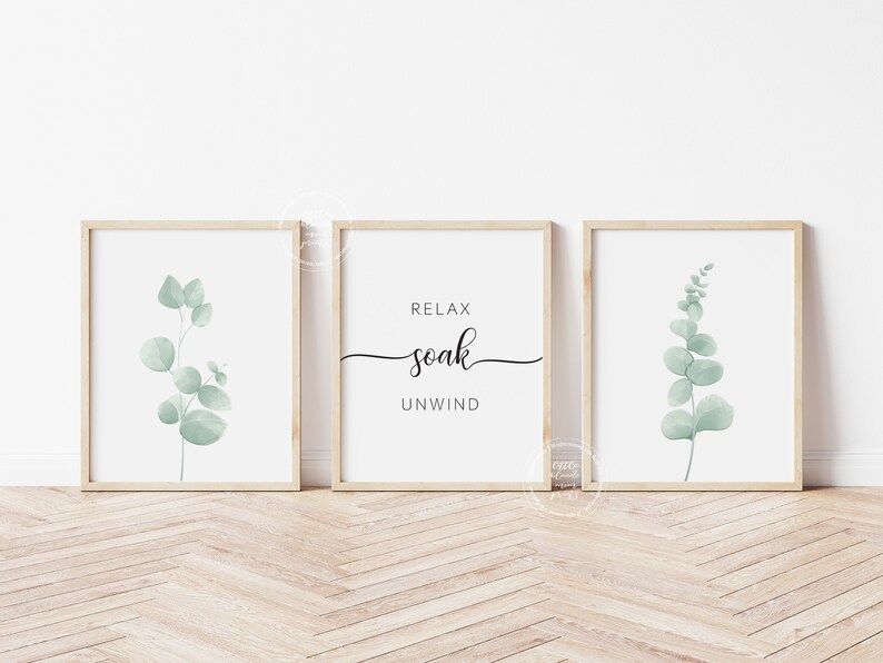 May include: Three framed prints with a minimalist design. The center print features the text "Relax soak unwind" in black script font. The left and right prints feature a watercolor illustration of a eucalyptus branch in shades of green.