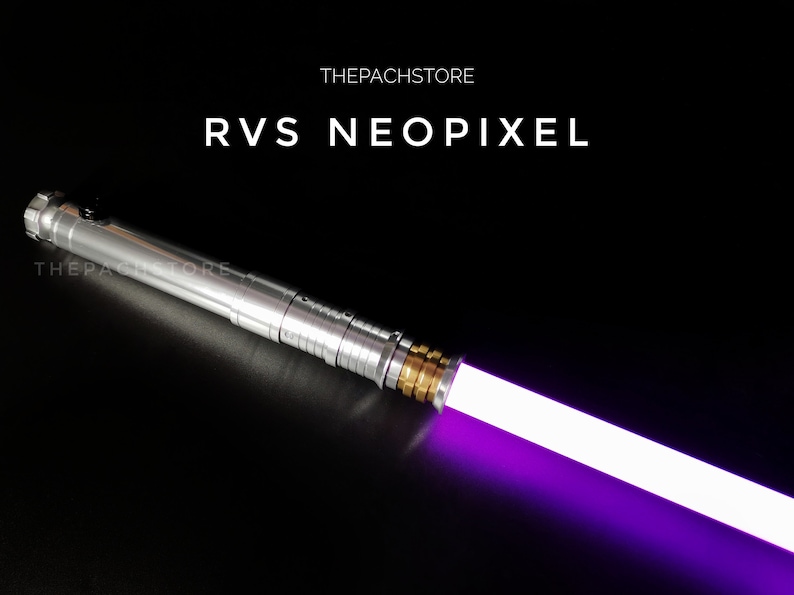 May include: A silver lightsaber with a purple blade. The lightsaber has a gold accent near the blade and the text "THEPACHSTORE" and "RVS NEOPIXEL" is visible.