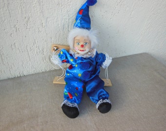 Vintage doll, Porcelain doll,  A clown doll  hanging on a bench, Clown doll, Collectible doll, Rag dlol Soft Doll, clown standing on a bench