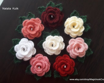 May include: Eight crocheted flowers in various colors, including red, pink, white, and cream. Each flower has a green leaf attached. The flowers are numbered 1 through 8.