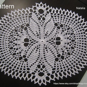 May include: White crochet doily with a circular pattern. The doily has a delicate, lacy design with a central motif. The text "Pattern" is visible in the top left corner of the image. The text "Natalia Kulik" is visible in the top right corner of the image. The text "https://www.etsy.com/shop/MagichookCrochetUA" is visible at the bottom of the image.