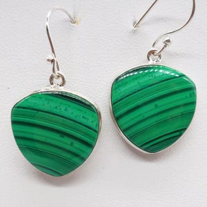 May include: A pair of silver earrings with green malachite stones. The stones are a triangular shape with a striated pattern.