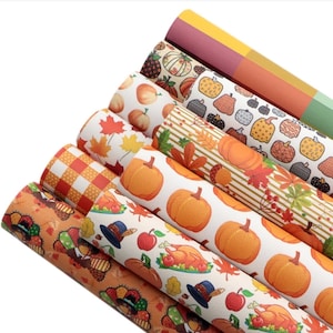 May include: A set of eight different patterned fabric sheets featuring fall themes. The patterns include pumpkins, turkeys, leaves, plaid, and a Thanksgiving dinner scene. The fabric sheets are perfect for crafting projects, scrapbooking, and decorating.