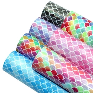 May include: A set of six iridescent mermaid scale faux leather sheets in various colors, including blue, pink, purple, and green. The sheets have a glittery finish and are perfect for crafting projects.