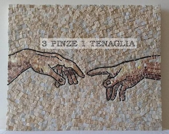 May include: A mosaic artwork depicting the famous "Creation of Adam" scene from Michelangelo's Sistine Chapel ceiling. The mosaic is made of small, colorful tiles and features two hands reaching towards each other. The text "3 PINZE 1 TENAGLIA" is written above the hands.