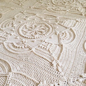 Crochet blanket on a bed.