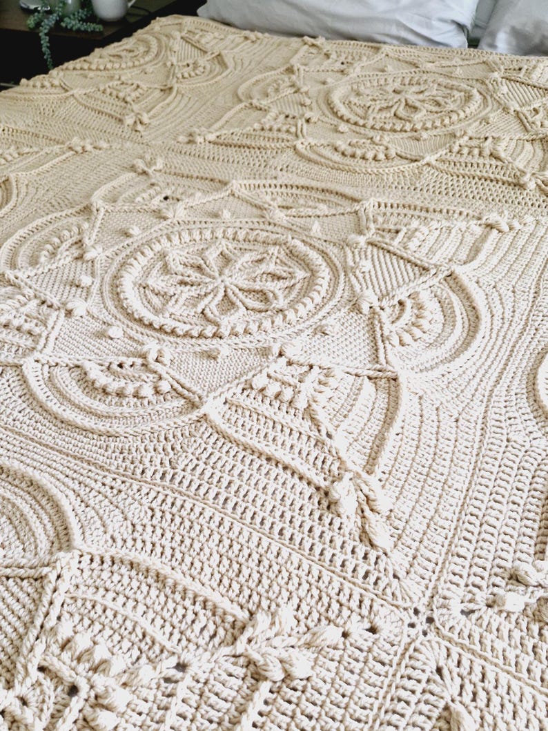 Crochet blanket on a bed.