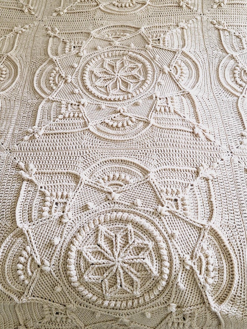 Crochet blanket on a bed.