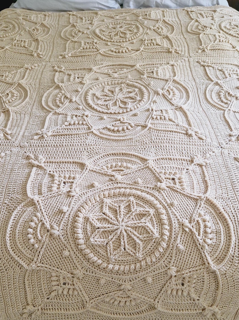 Textured crochet blanket on queen-size bed.