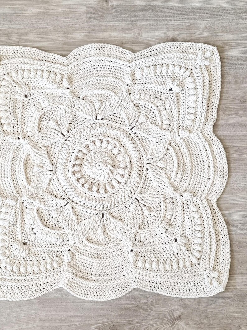 Square, white crochet floor rug.