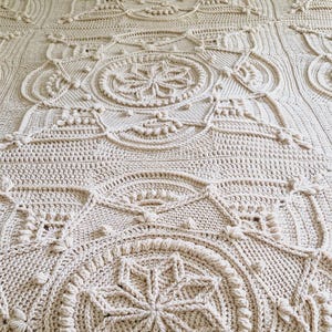 Crochet blanket on a bed.