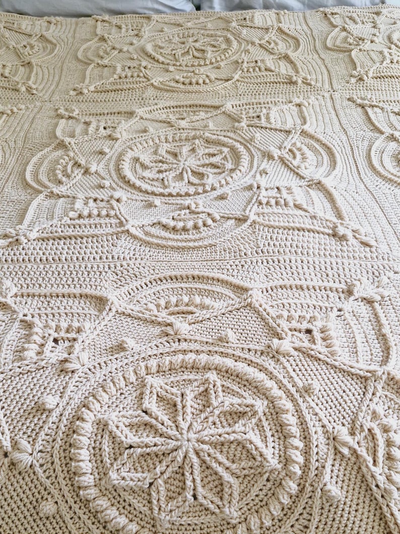 Crochet blanket on a bed.