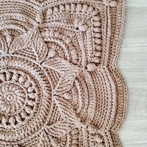 Square, brown crochet floor rug.