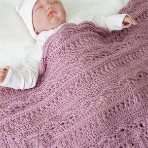 Pink crochet blanket with baby.