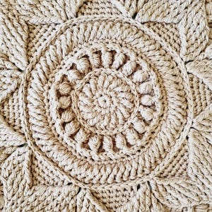 Square, brown crochet floor rug.