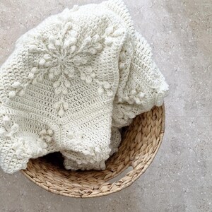 Cream crochet blanket in a basket