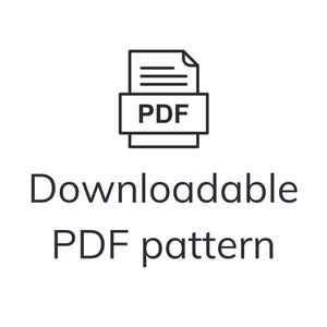 May include: A black and white graphic of a PDF icon above the words "Downloadable PDF pattern". The PDF icon is a stack of papers with the letters "PDF" in a box. The text is in a clean, sans-serif font.