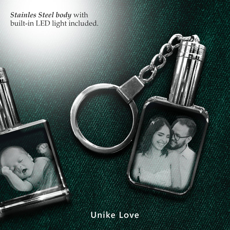 May include: A silver keychain with a built-in LED light and a crystal photo charm. The charm features a black and white photo of a couple. The text "Unike Love" is printed below the charm.