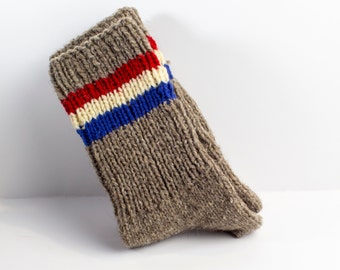 May include: A brown wool sock with a red, white and blue striped pattern.