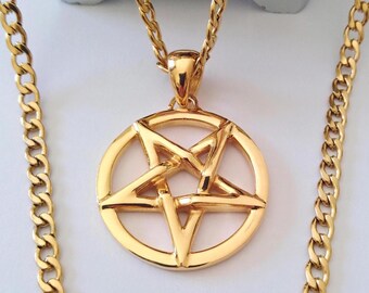 May include: A gold-toned metal necklace featuring a circular pendant with a five-pointed star pentagram design. The pendant is suspended from a matching gold-toned curb chain with interlocking links, showcasing a polished, reflective metallic finish.