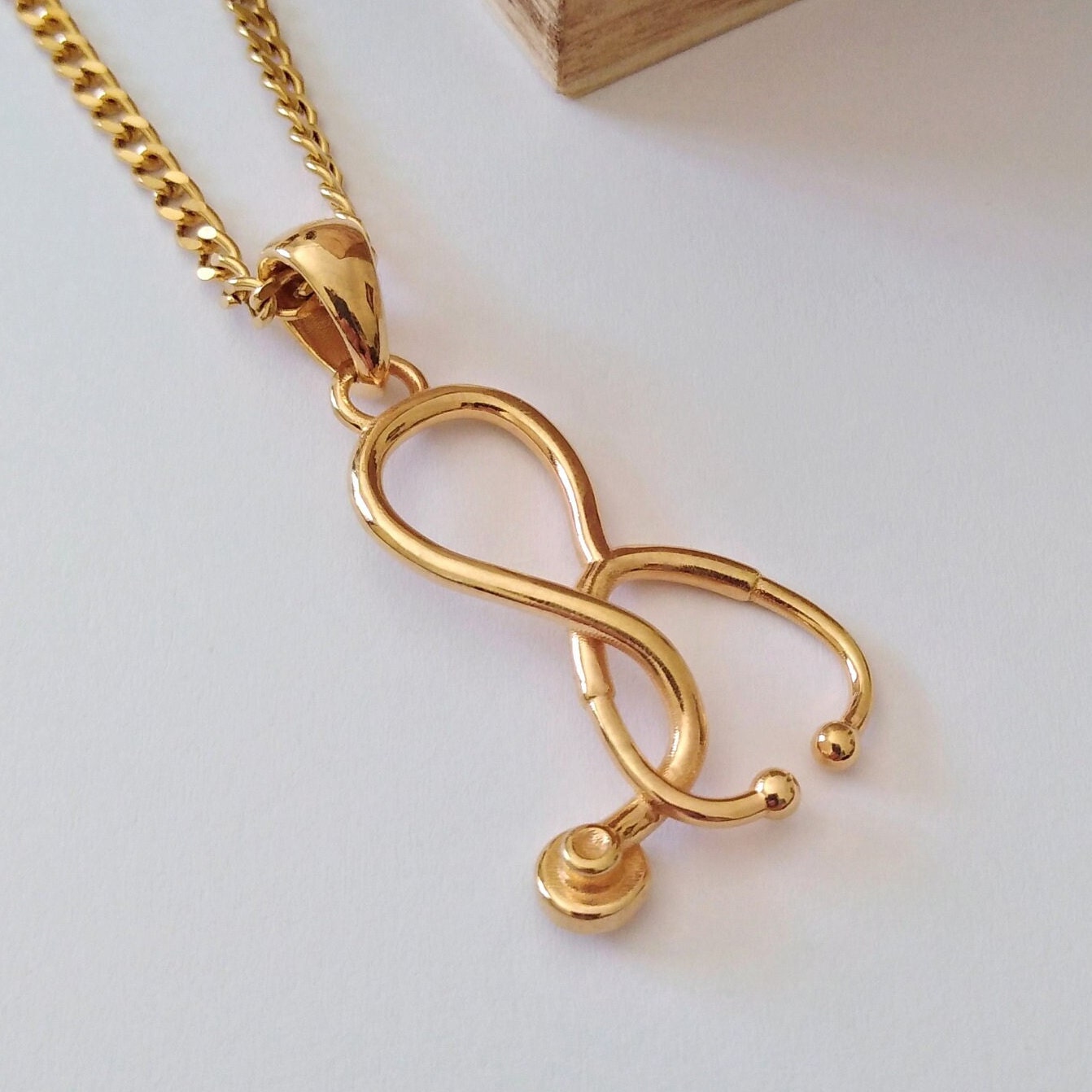 Gold stethoscope necklace discount