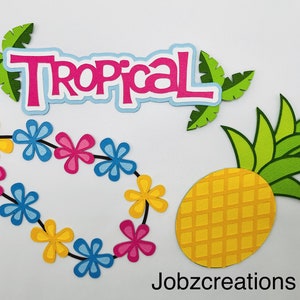 May include: Tropical party decorations with a pineapple, lei, and the word "Tropical" in pink, blue, and green letters.