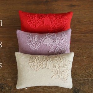 Newborn posing pillow — soft pastel shades, plush support, and essential prop for cozy, timeless baby photography