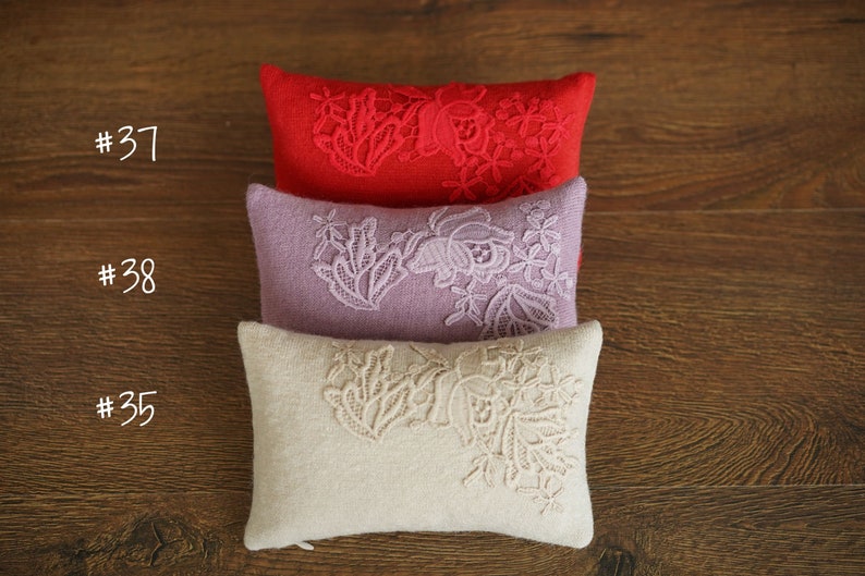 Newborn posing pillow — soft pastel shades, plush support, and essential prop for cozy, timeless baby photography
