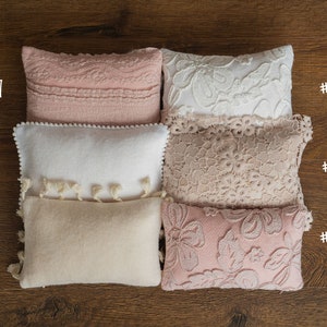 Newborn posing pillow — soft pastel shades, plush support, and essential prop for cozy, timeless baby photography