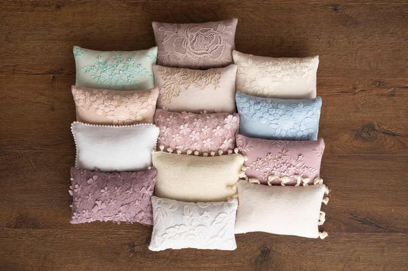 Soft newborn photo pillow with posing fabric, styled as a photography prop for newborn sessions