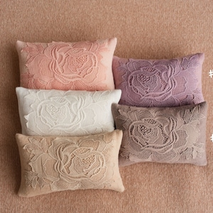 Newborn posing pillow — soft pastel shades, plush support, and essential prop for cozy, timeless baby photography