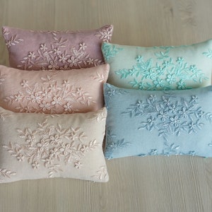 Newborn posing pillow — soft pastel shades, plush support, and essential prop for cozy, timeless baby photography