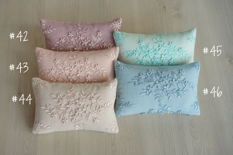Newborn posing pillow — soft pastel shades, plush support, and essential prop for cozy, timeless baby photography