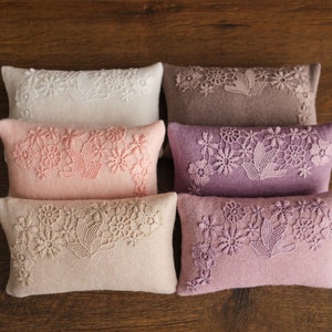 Newborn posing pillow — soft pastel shades, plush support, and essential prop for cozy, timeless baby photography