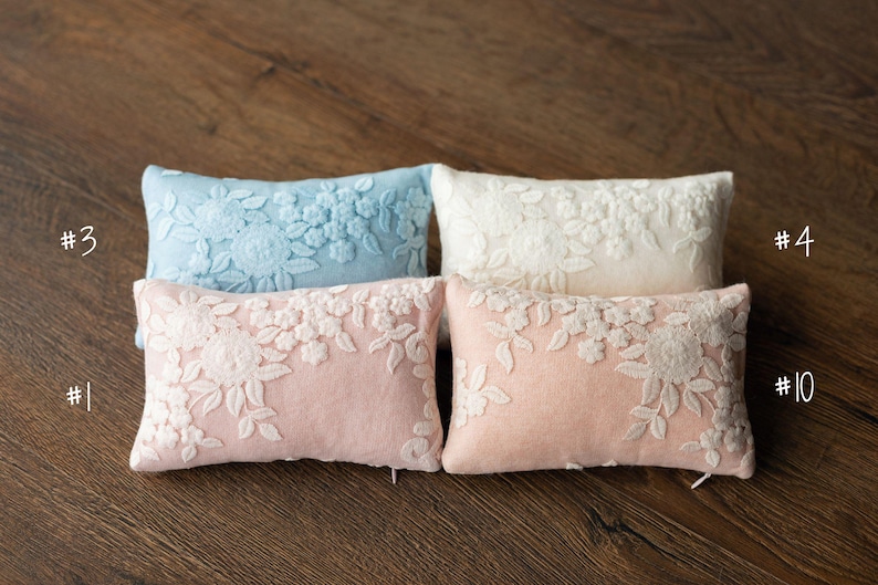 Newborn posing pillow — soft pastel shades, plush support, and essential prop for cozy, timeless baby photography