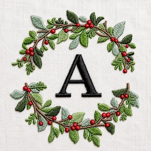 Può includere: Un disegno ricamato su tessuto bianco con una lettera A maiuscola nera centrata all'interno di una ghirlanda circolare. La ghirlanda è composta da rami marroni, foglie di varie tonalità di verde e piccole bacche rosse in un motivo botanico.