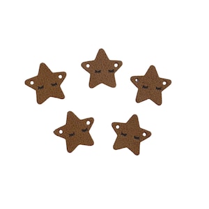 May include: Five brown leather star-shaped embellishments with black embroidered eyes. Each star has two small holes at the top.