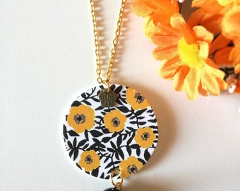 Long necklace with paper circle pendant, beautiful black, black and yellow floral image and black stone