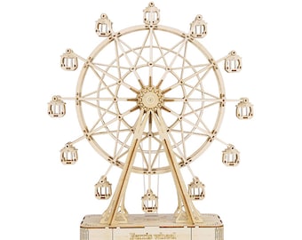 May include: A wooden model of a Ferris wheel with 12 gondolas. The wheel is made of light brown wood and has a dark brown base. The base has the words "Ferris wheel" inscribed on it.