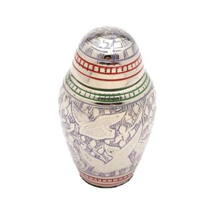 May include: A small silver urn with a purple floral design and red and green trim. The urn has a lid and is about 4 inches tall.