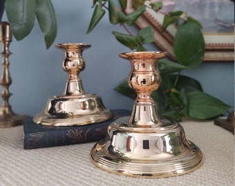 Vintage pair of polished brass candlesticks with large base